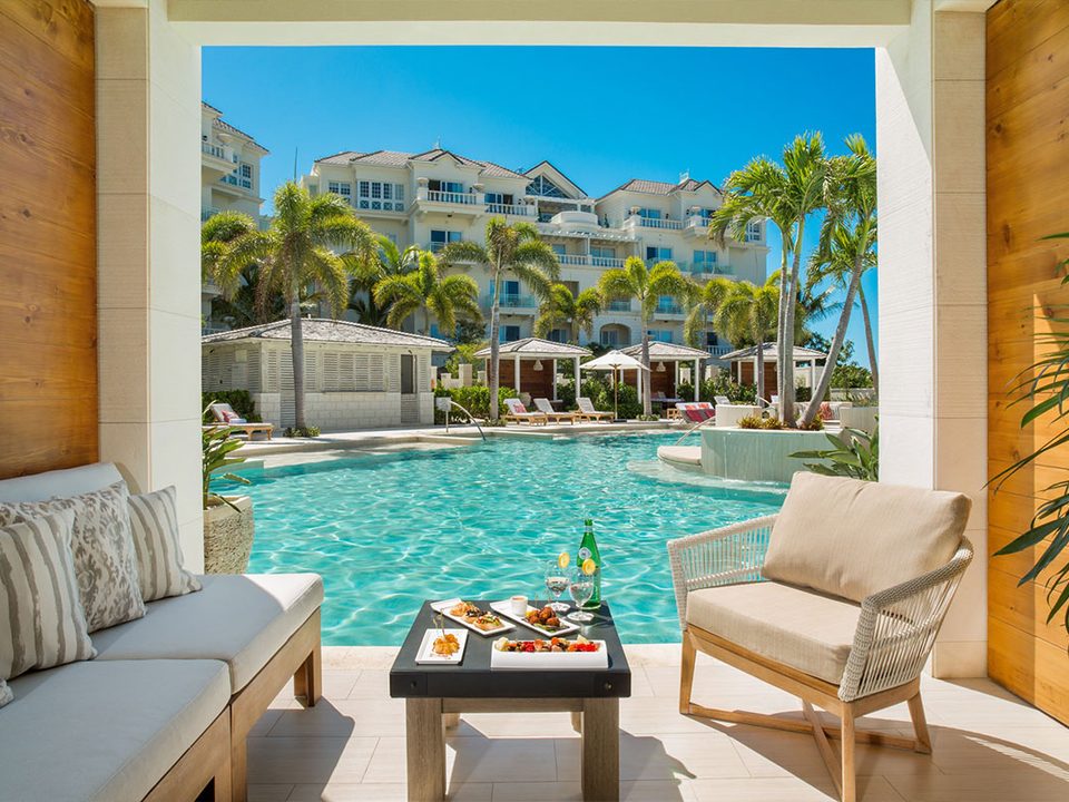 A poolside cabana looking over the pool to the resort