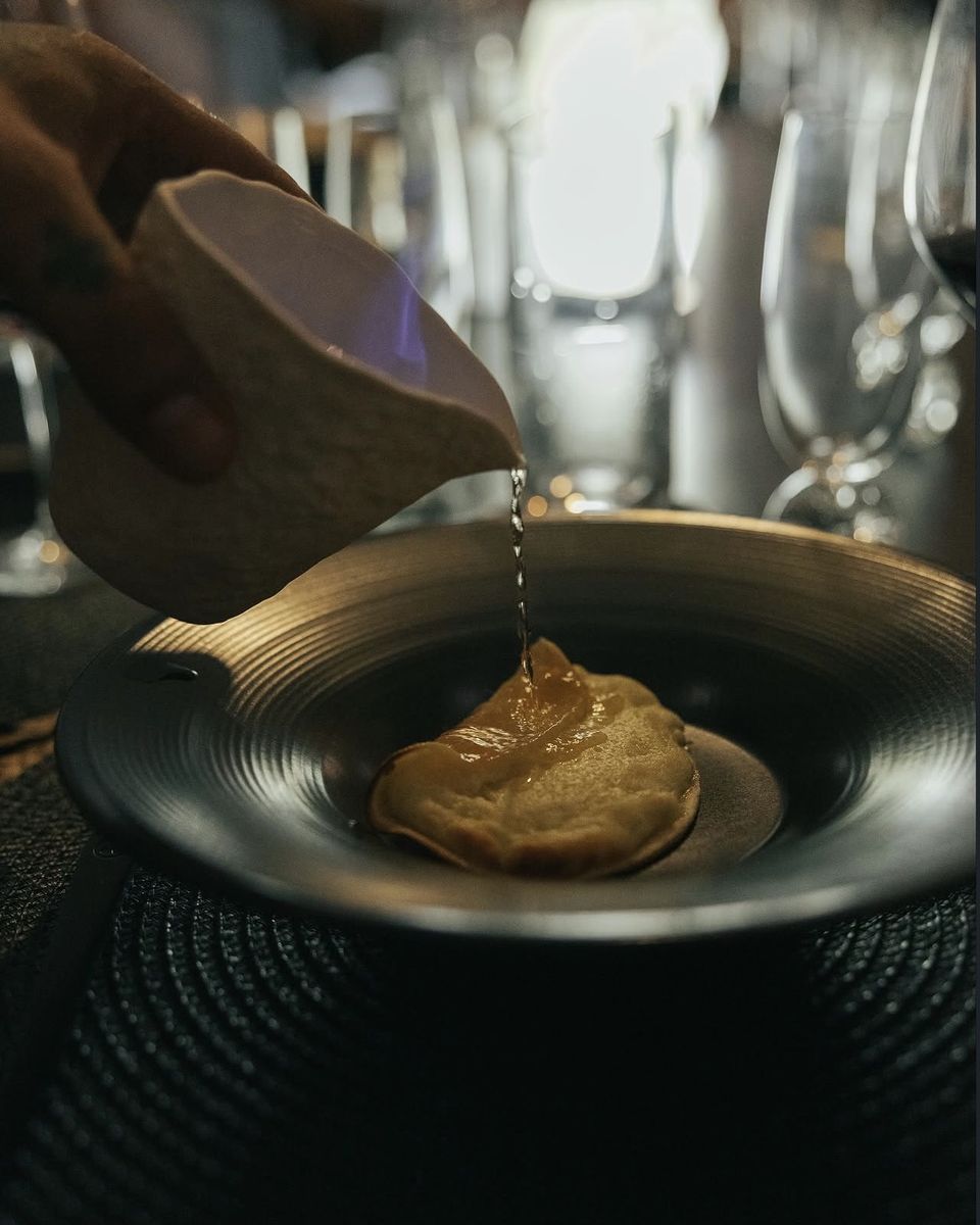 Sauce poured at the table over a large raviolo at Ode to Gillian