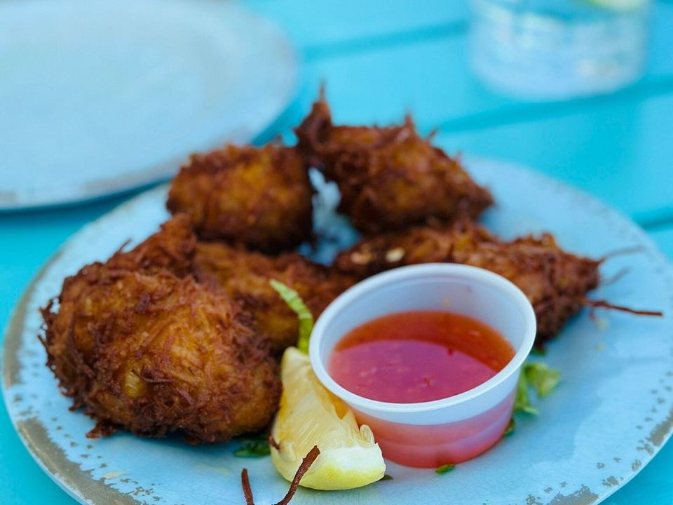 Conch fritters with a dipping sauce and lemon at Omar's Beach Hut