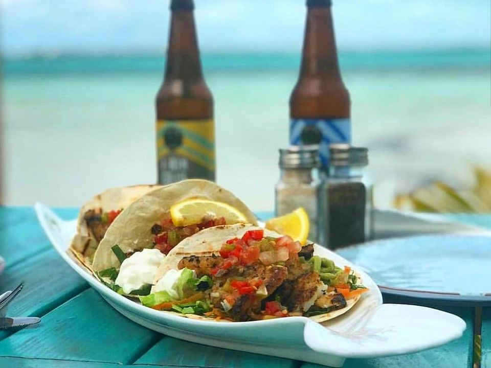 Fish tacos and two cold beers by the water at Omar's Beach Hut