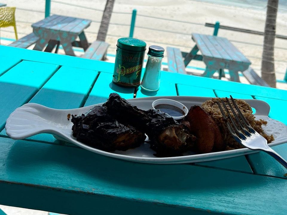 A jerk plate with sweet plantain and peas and rice at Omar's Beach Hut, above the beach