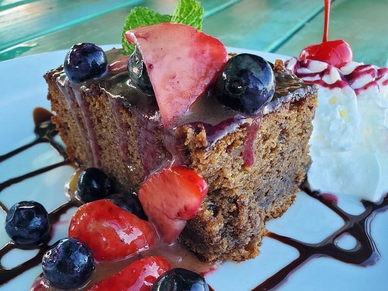 Rum cake with fresh berries and chocolate sauce at Omar's Beach Hut