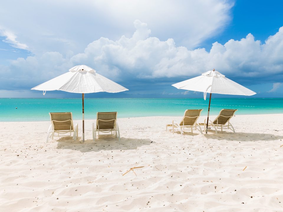 Loungers and white umbrellas on the sand