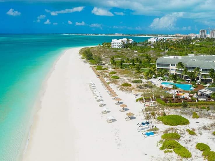 Grace Bay Beach from above, with The Sands among the palms