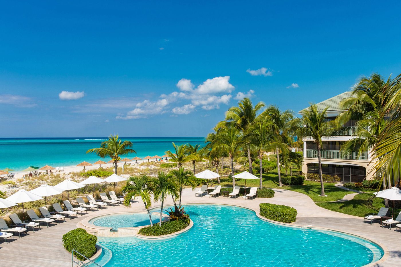 The Sands' pools and gardens running down to Grace Bay Beach