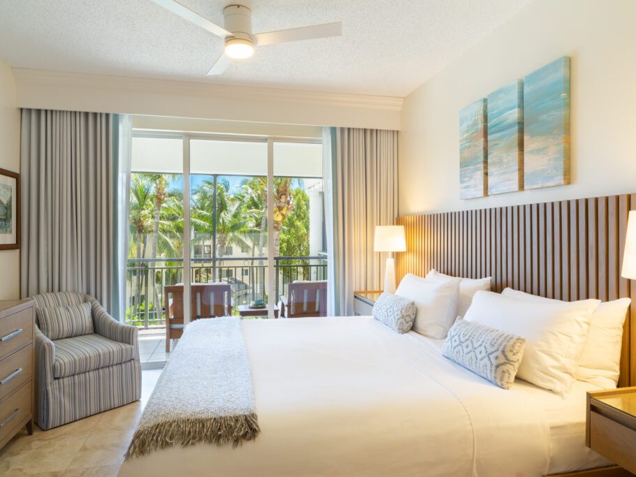 A suite bedroom with the balcony beyond