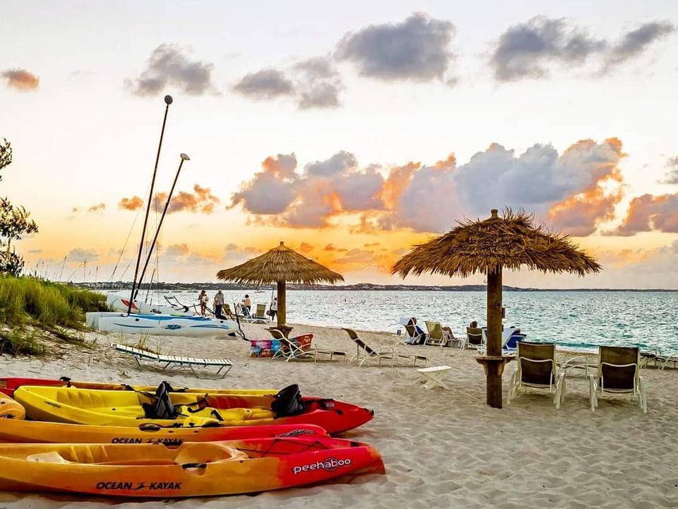Kayaks and a Hobie Cat on the beach