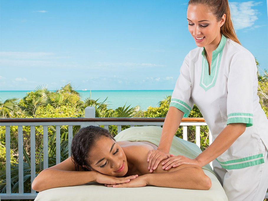 A massage on a spa bungalow deck above the sea