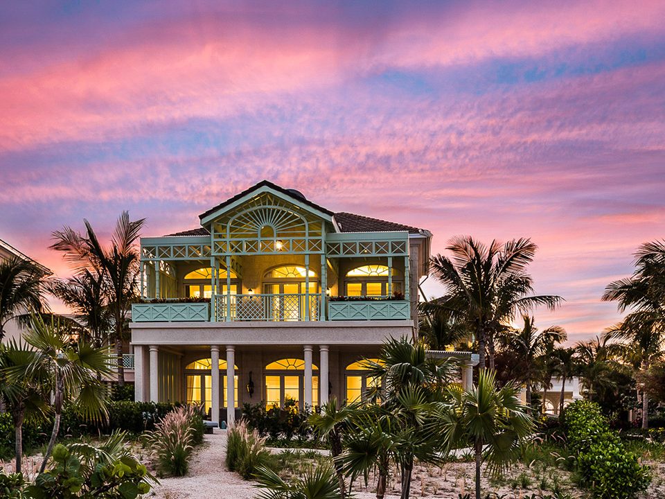 An Estate Villa lit up at sunset