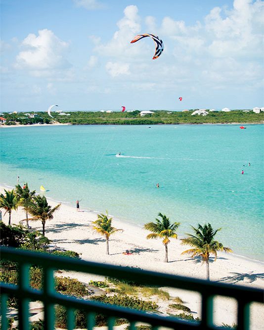 Kiteboarders on Long Bay, seen from a balcony