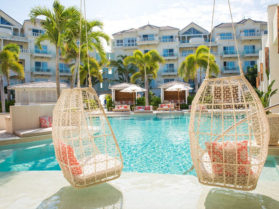 Wicker swing chairs hanging over the edge of the pool