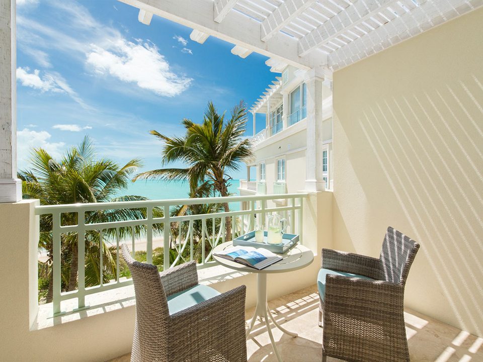 A suite balcony looking through the palms to the sea