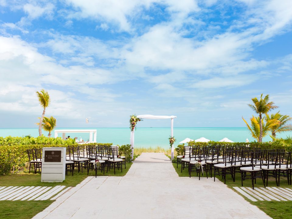 Chairs set for a wedding along the boardwalk to the beach