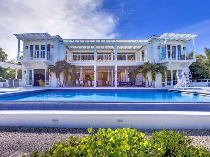 A two-storey villa with a pool and water slide