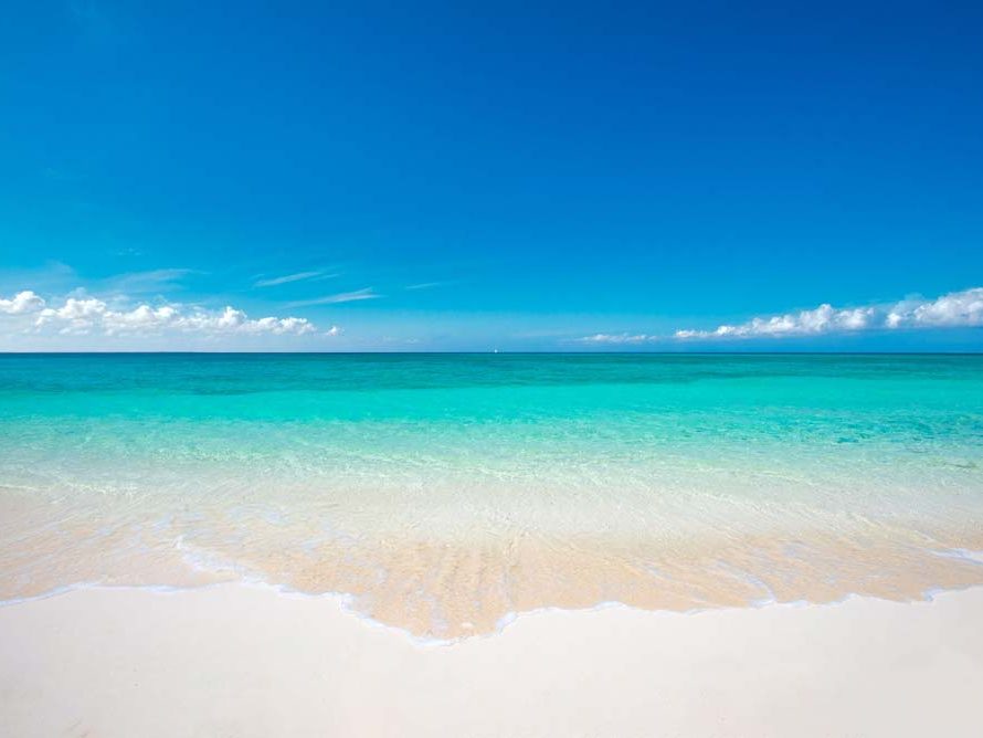 Clear turquoise water lapping on white sand